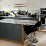 This striking Classy Reflection Kitchen is achieved with two complimenting Farrow & Ball colours with distinctive oak accents and mirror splashback.