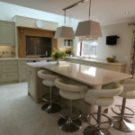 This Sleek & Sophisticated Kitchen designed by Knights Country Kitchens, highlights soft cream and greys, coupled with an italian porcelain floor. Integrated oven, wine cooler and oak worktops to compliment the sleek design. Bespoke Kitchens